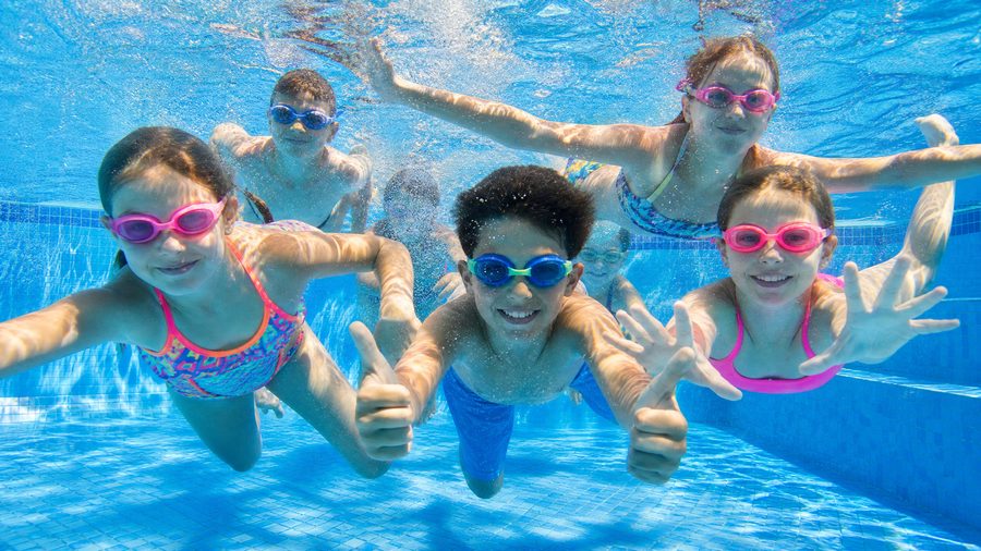 Kids swimming safely in a shallow pool zone